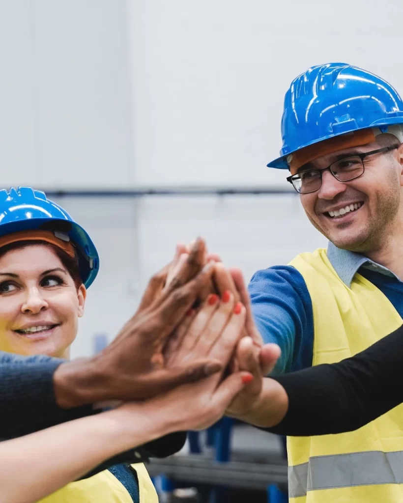 happy-multiracial-engineer-stacking-hands-while-wo-2023-11-27-05-21-20-utc